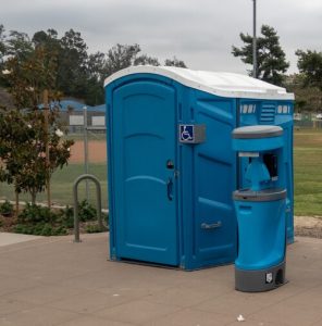 wheelchair accessible porta potty with a hand washing station